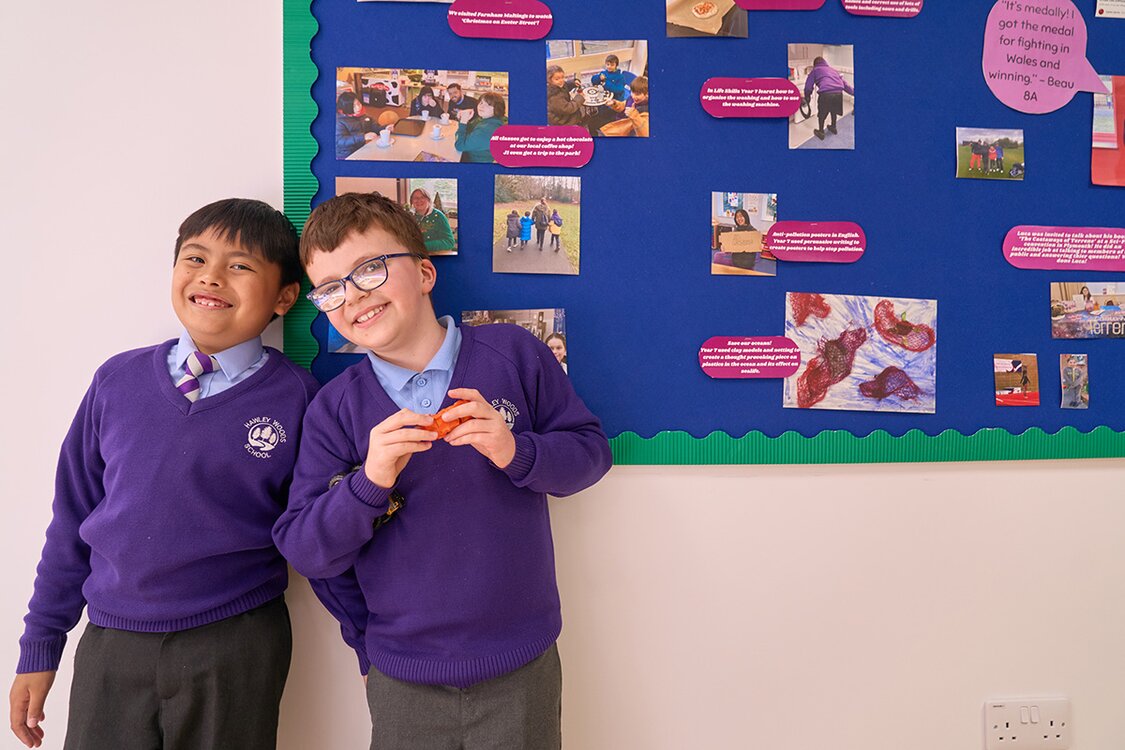 two smiling children in school uniform