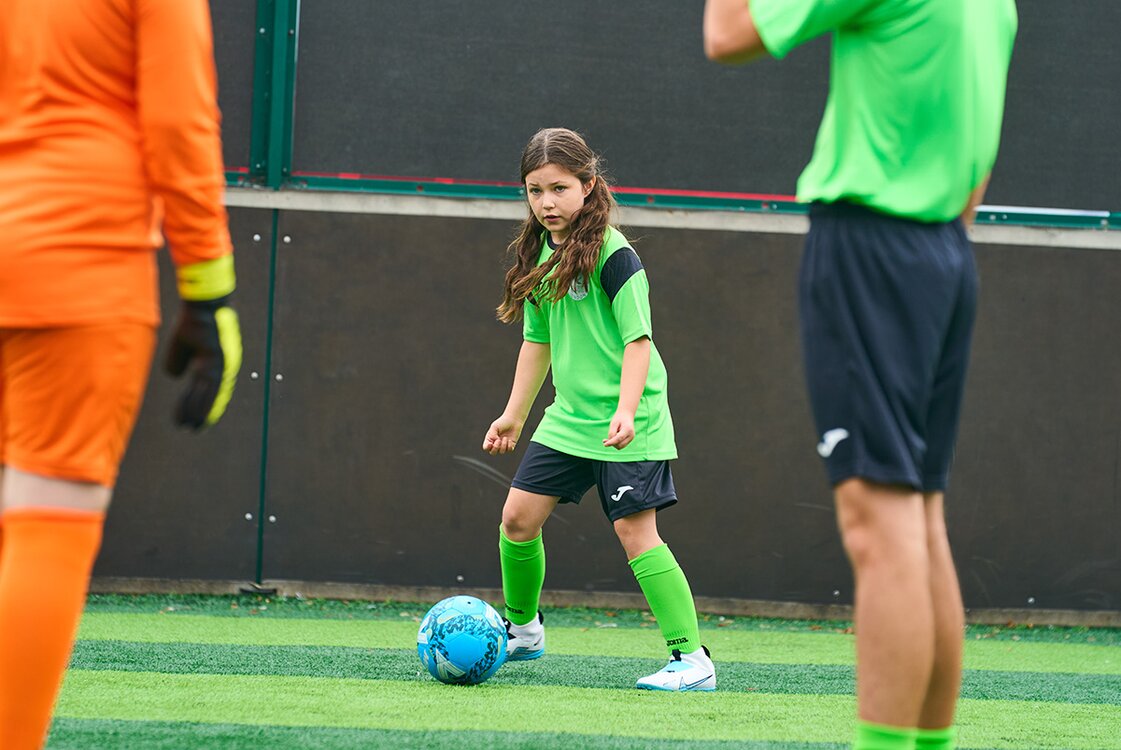 girl plays football