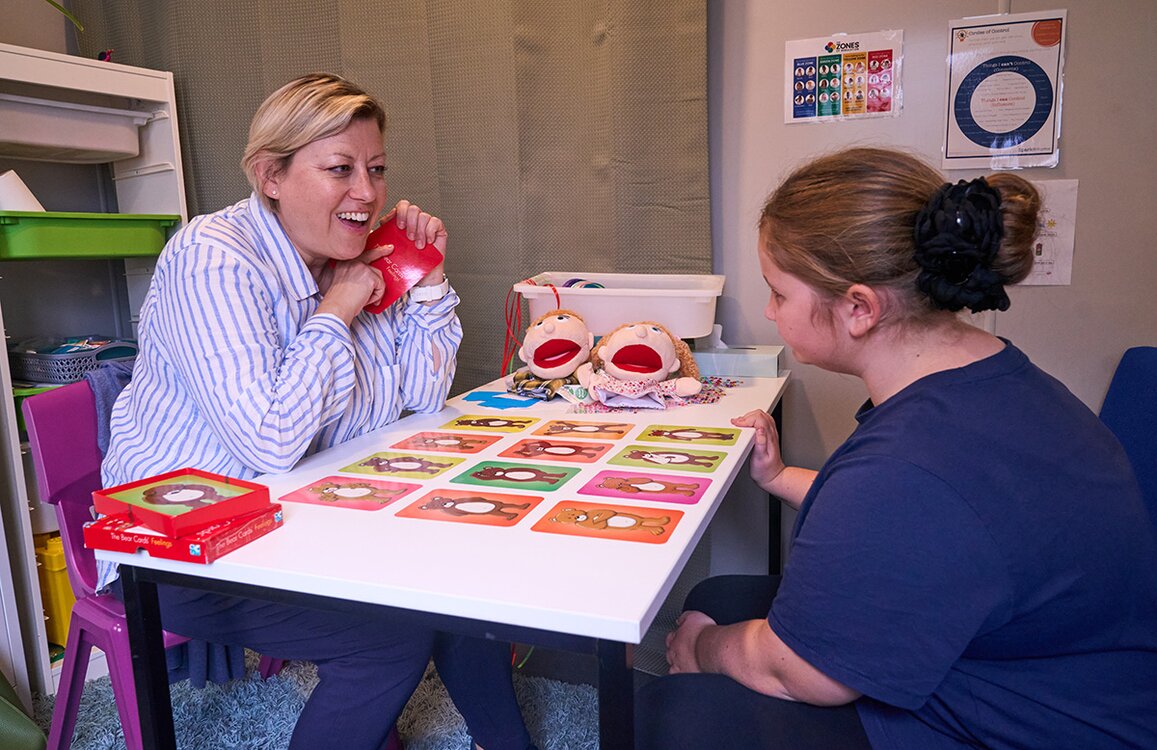 child and therapist playing a game