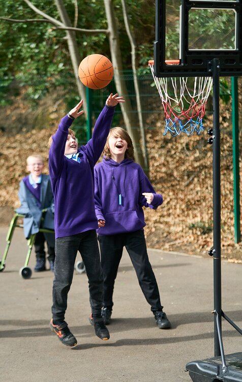 children in school uniform play basketball