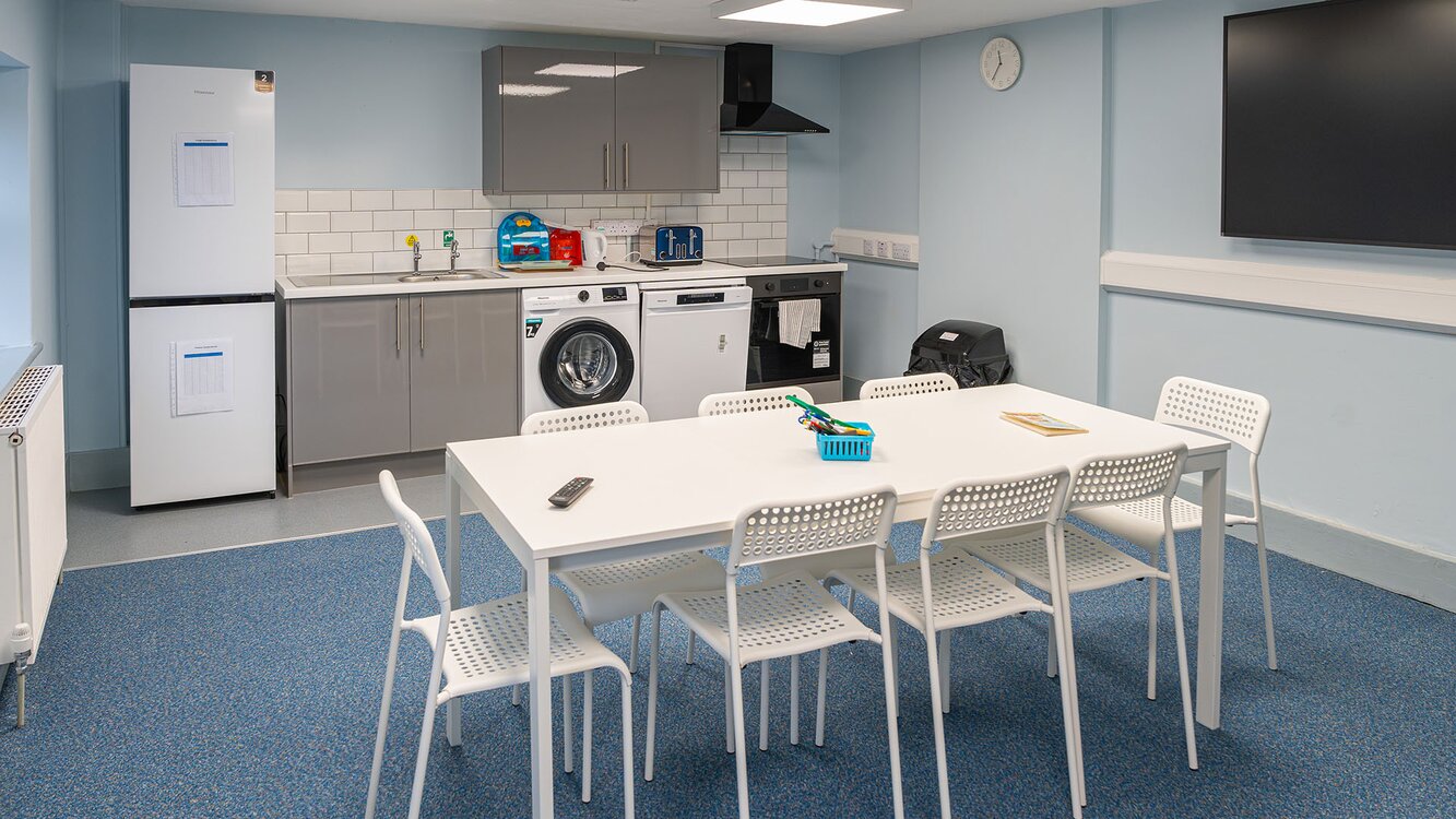 table and chairs and kitchenette in life skills flat