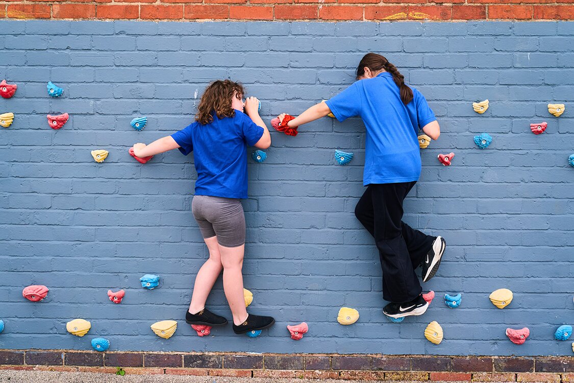 two children on a climbing wall