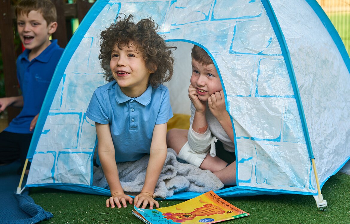 child sticking head out of a tent