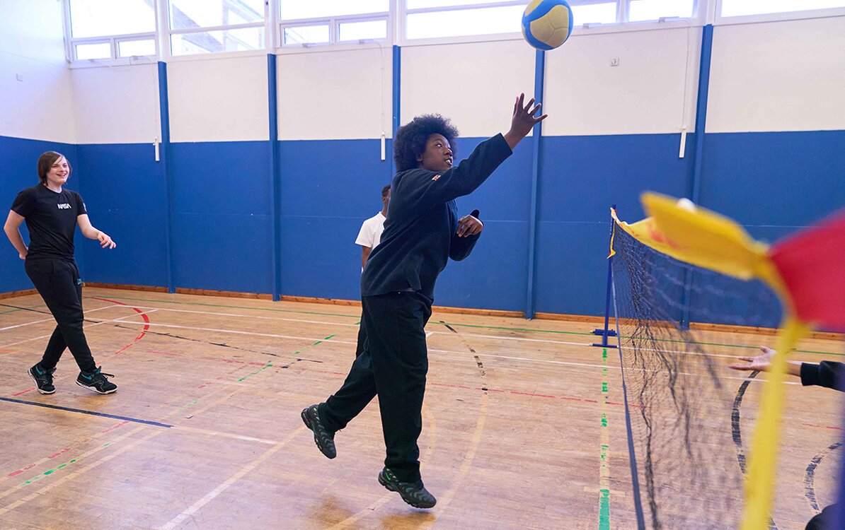 child playing volleyball