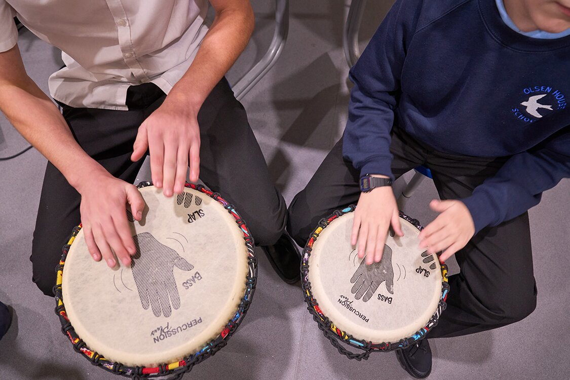 view from above of two children drumming