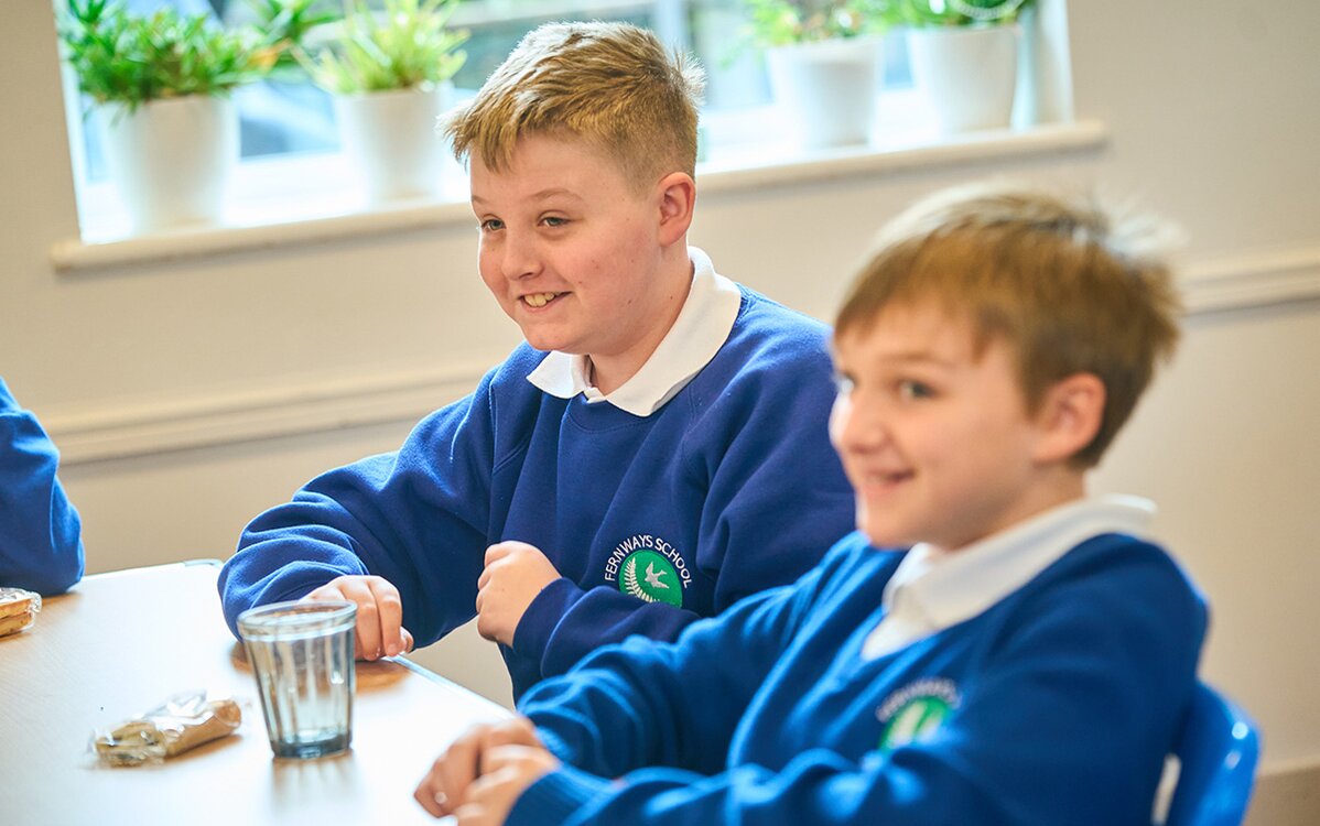 children sat at a table laughing