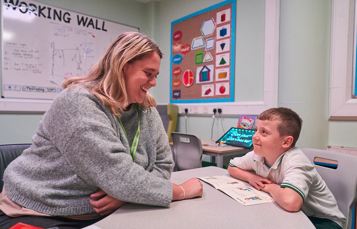 child looks up at staff member