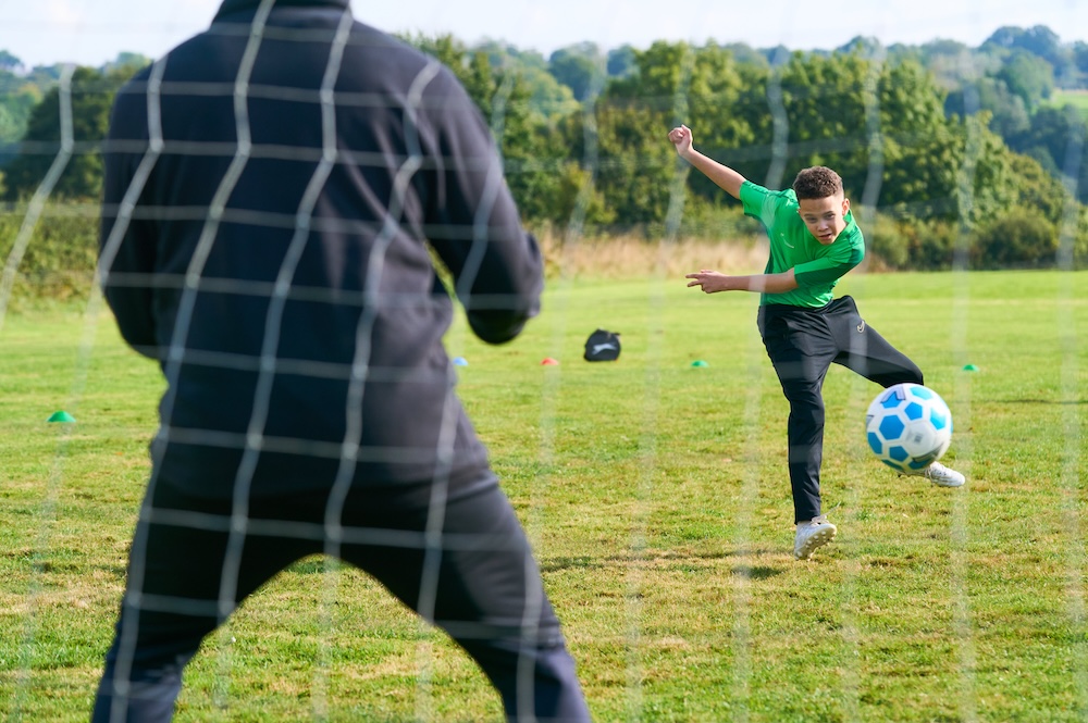 student playing football
