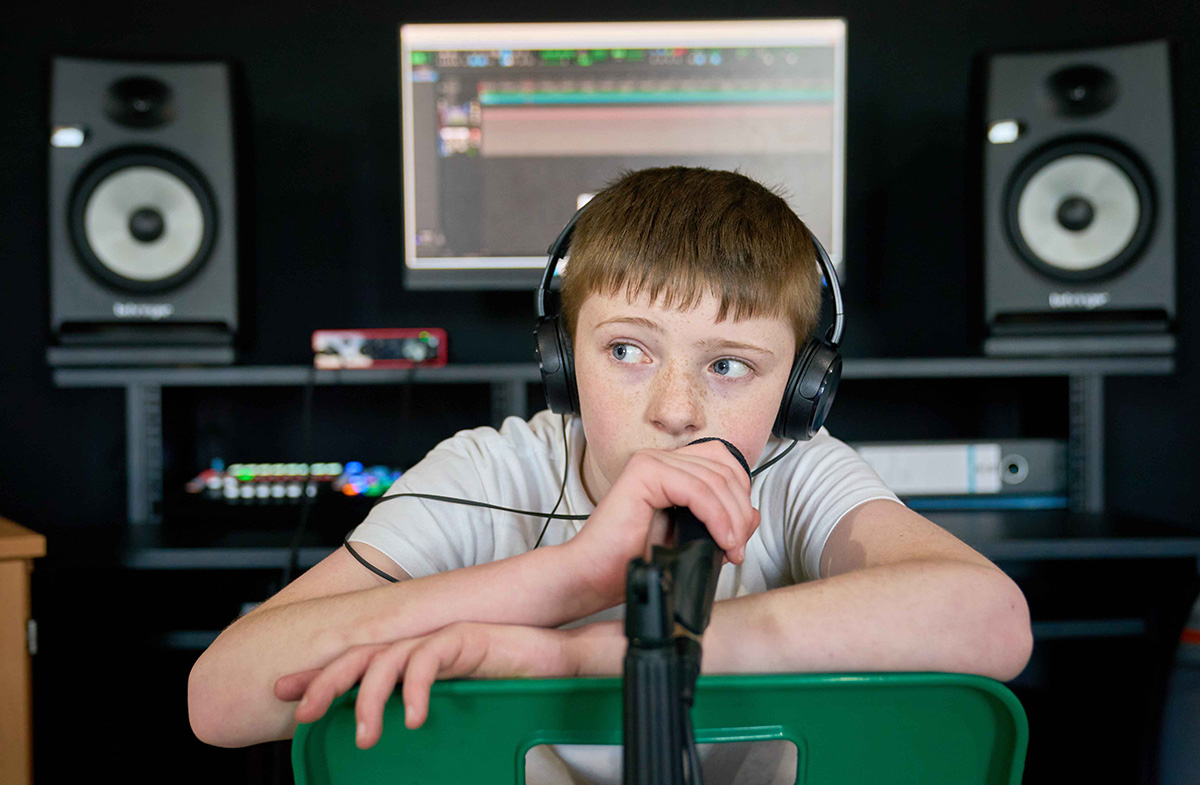 child using microphone wearing headphones
