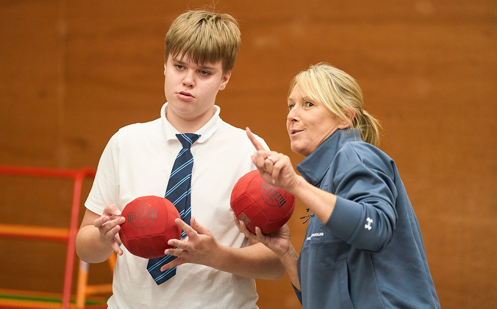 Pupil and teacher talking holding soft balls