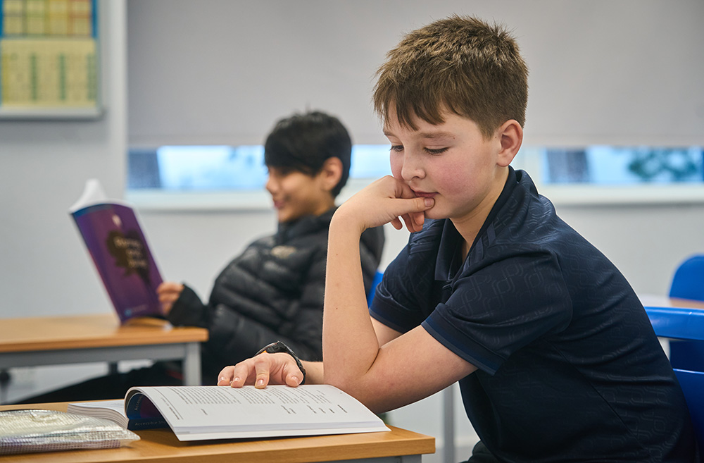 pupils reading sat at desks 