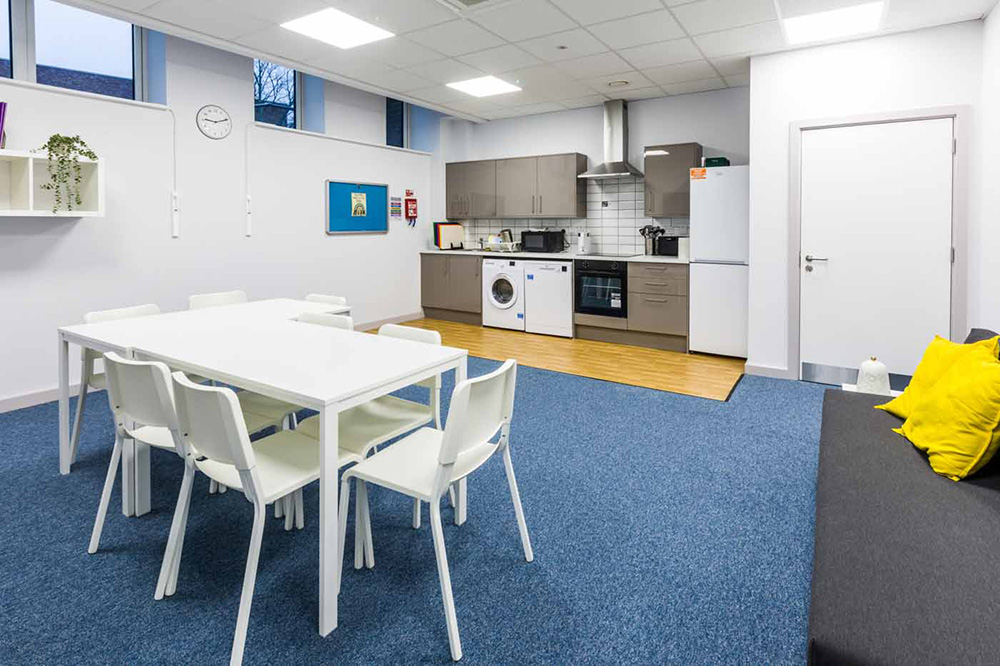 table and chairs and kitchenette area make up the life skills flat 