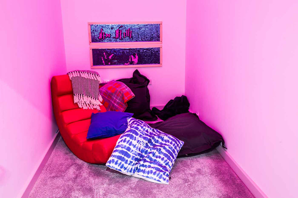 a relaxed sensory room with lighting and soft furnishings