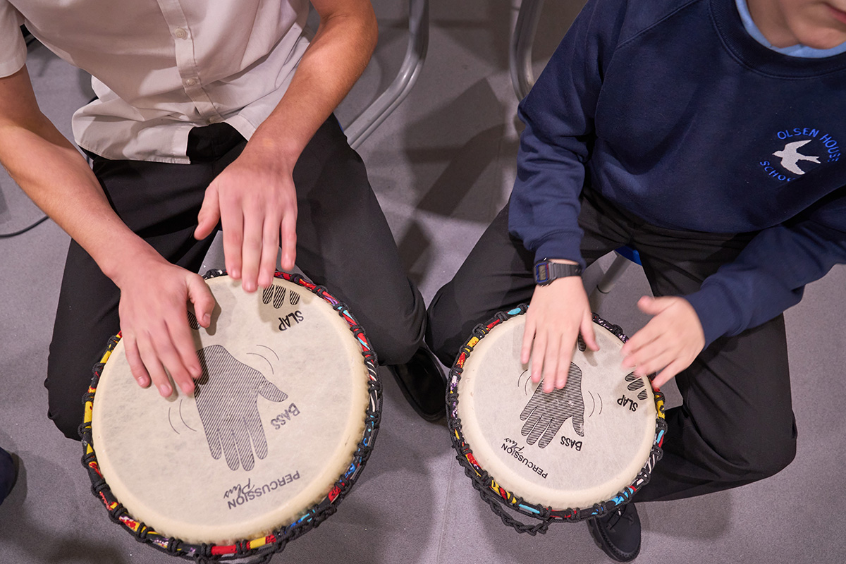 view from above of two children drumming